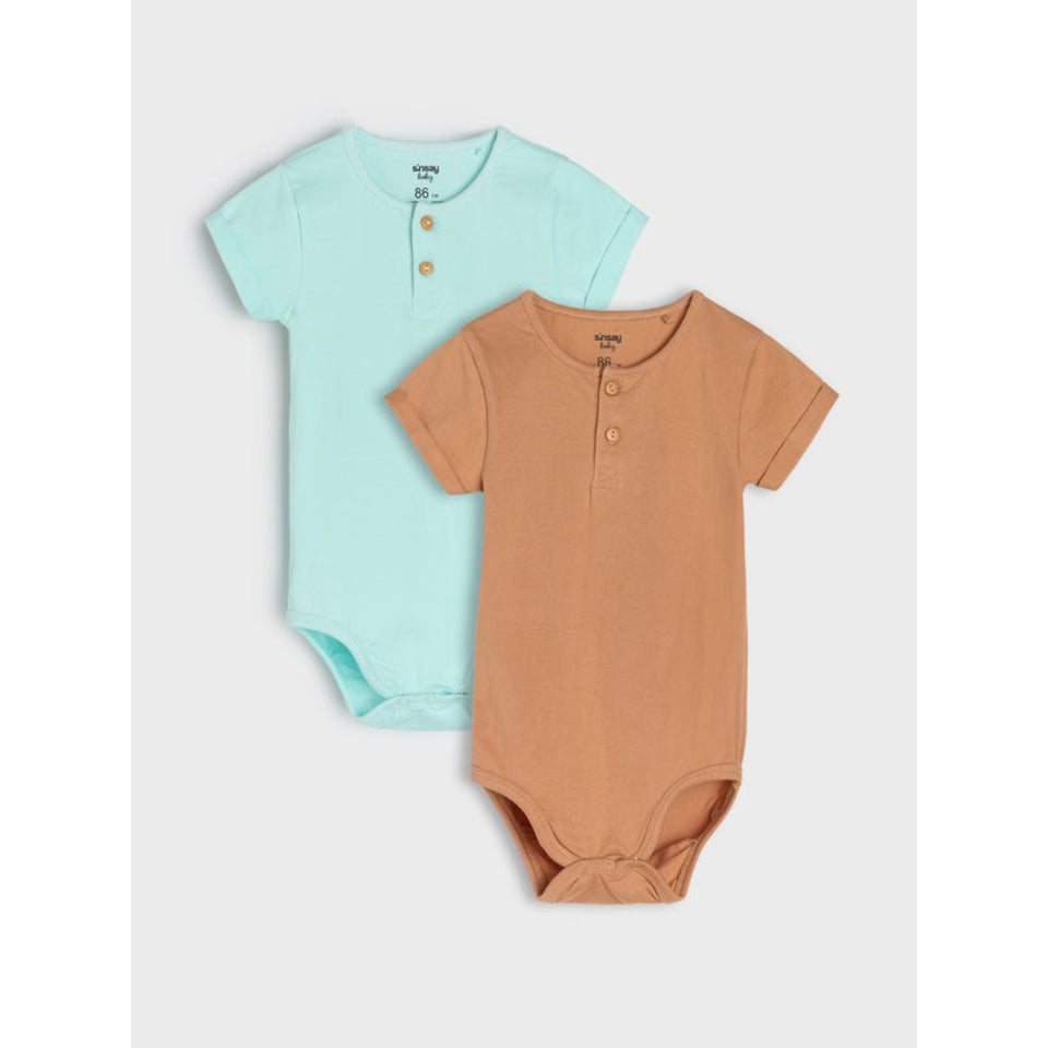 Two short-sleeve baby bodysuits from Vionnet Paris, one in light mint green and the other in warm terracotta, both featuring a three-button henley neckline, displayed on a light gray background.