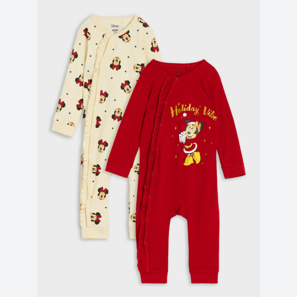 Two baby long-sleeve footless sleepers shown on a light gray background. The front sleeper is bright red with a 'Holiday Vibe' Christmas elf graphic and yellow text.