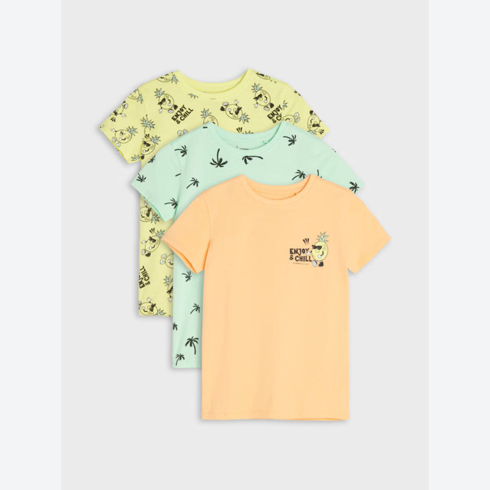 Three children's short-sleeve t-shirts stacked in a fan arrangement on a light gray background. The front shirt is peach-orange with a small graphic on the chest, the middle shirt is mint green with a palm tree print, and the back shirt is pale yellow with a cartoon animal print.
