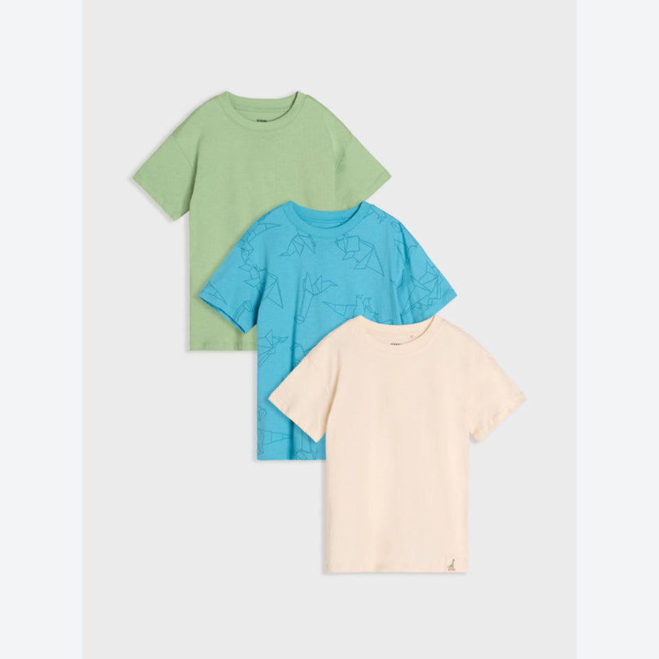 Three short-sleeve kids' crewneck t-shirts in sage green, light blue with a subtle line-art pattern, and light peach, arranged in a stacked layout on a light gray background.