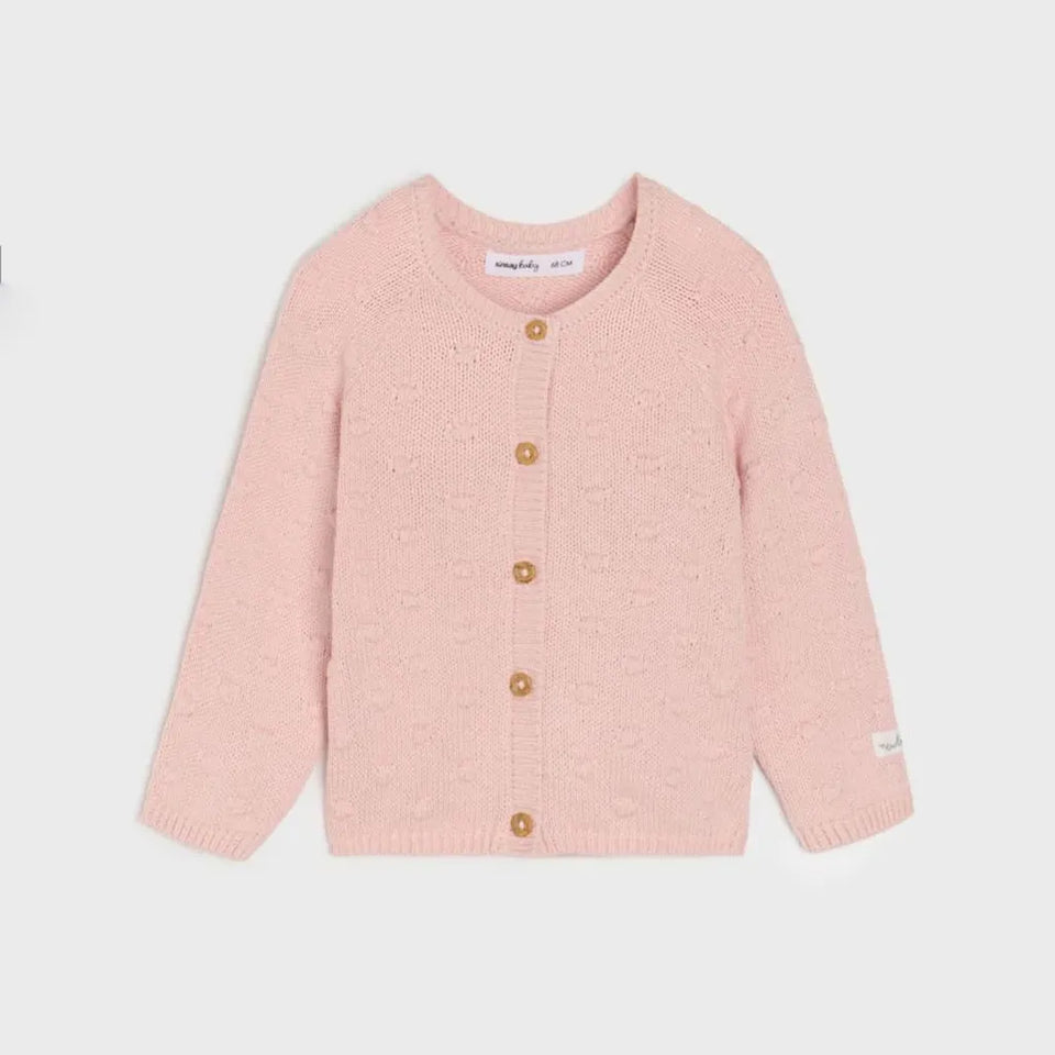 A light pink knit cardigan sweater for toddlers, featuring a round neckline, front button closure with wooden buttons, and ribbed cuffs and hem, shown against a light gray background.