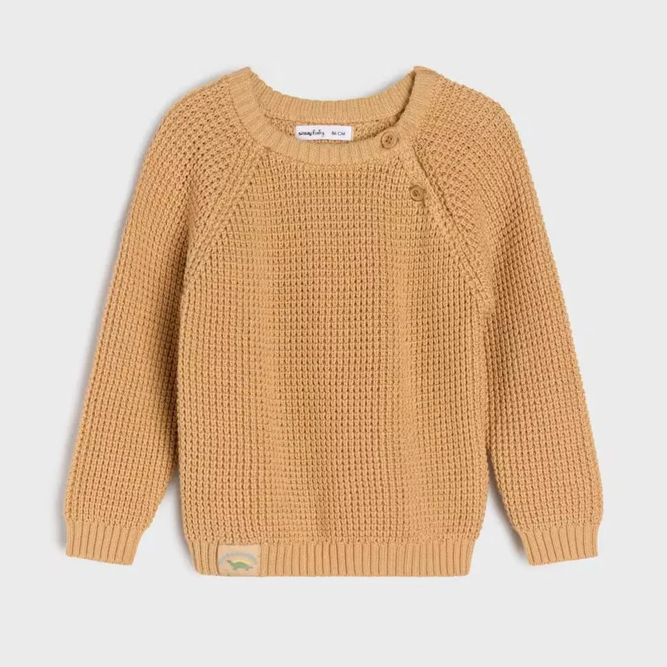 A mustard yellow textured knit baby sweater with long raglan sleeves, a round neckline, and an asymmetrical button closure on the chest, shown flat on a light gray background.