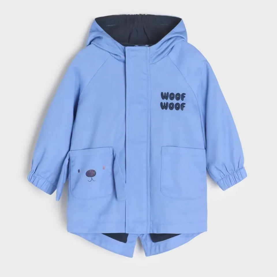A light blue hooded raincoat with 'WOOF WOOF' printed on the chest and a small dog face detail on the front pocket, shown against a light gray background.