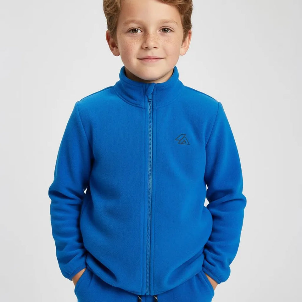 A young boy wearing a bright blue fleece zip-up jacket with a small dark embroidered logo on the left chest, photographed against a light gray studio background.