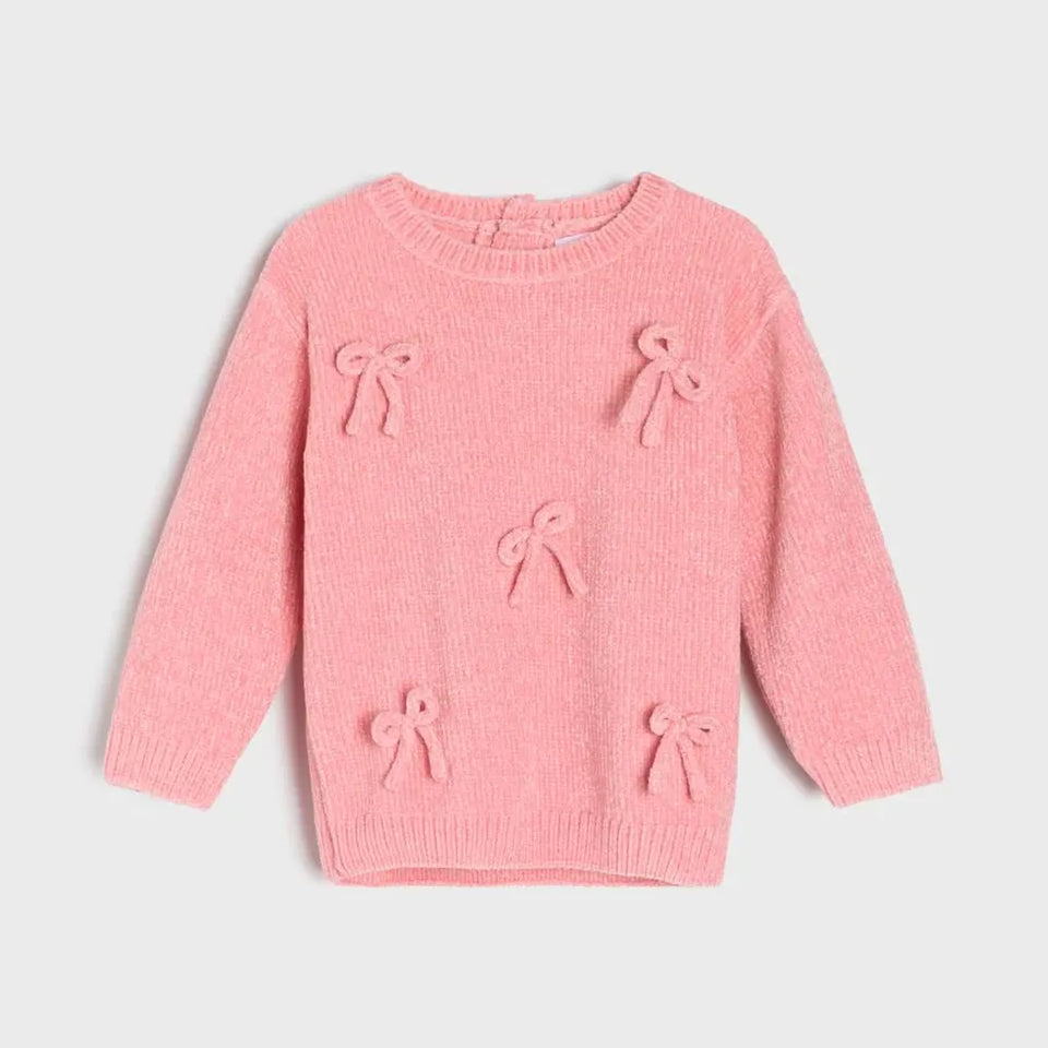 A pink knit sweater for toddlers, featuring three-dimensional textured bow details on the front, displayed against a light gray background.