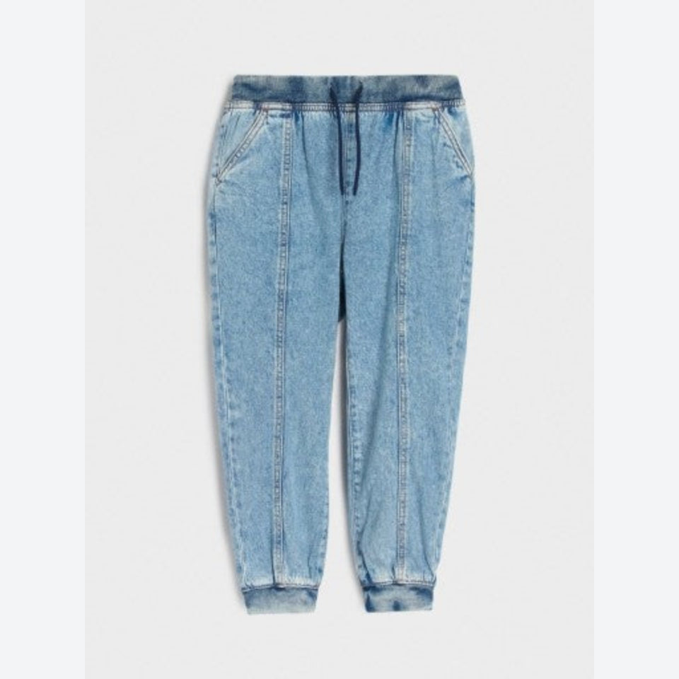 Light blue denim jogger pants with an elastic waistband, drawstring, and cuffed ankles, shown flat on a light gray background.