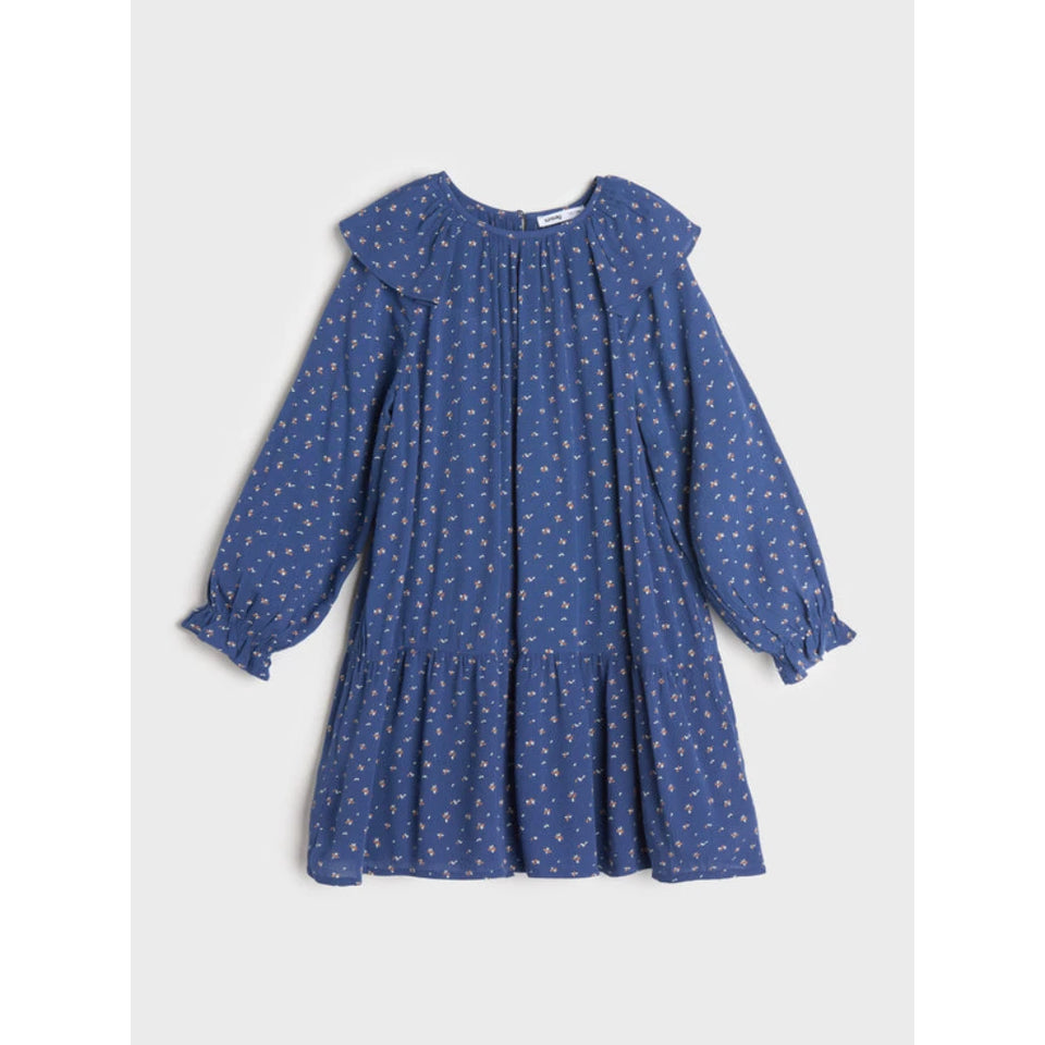 A blue long-sleeve babydoll dress with a small white and yellow floral print, featuring a ruffled collar and tiered skirt, shown flat on a light gray background.