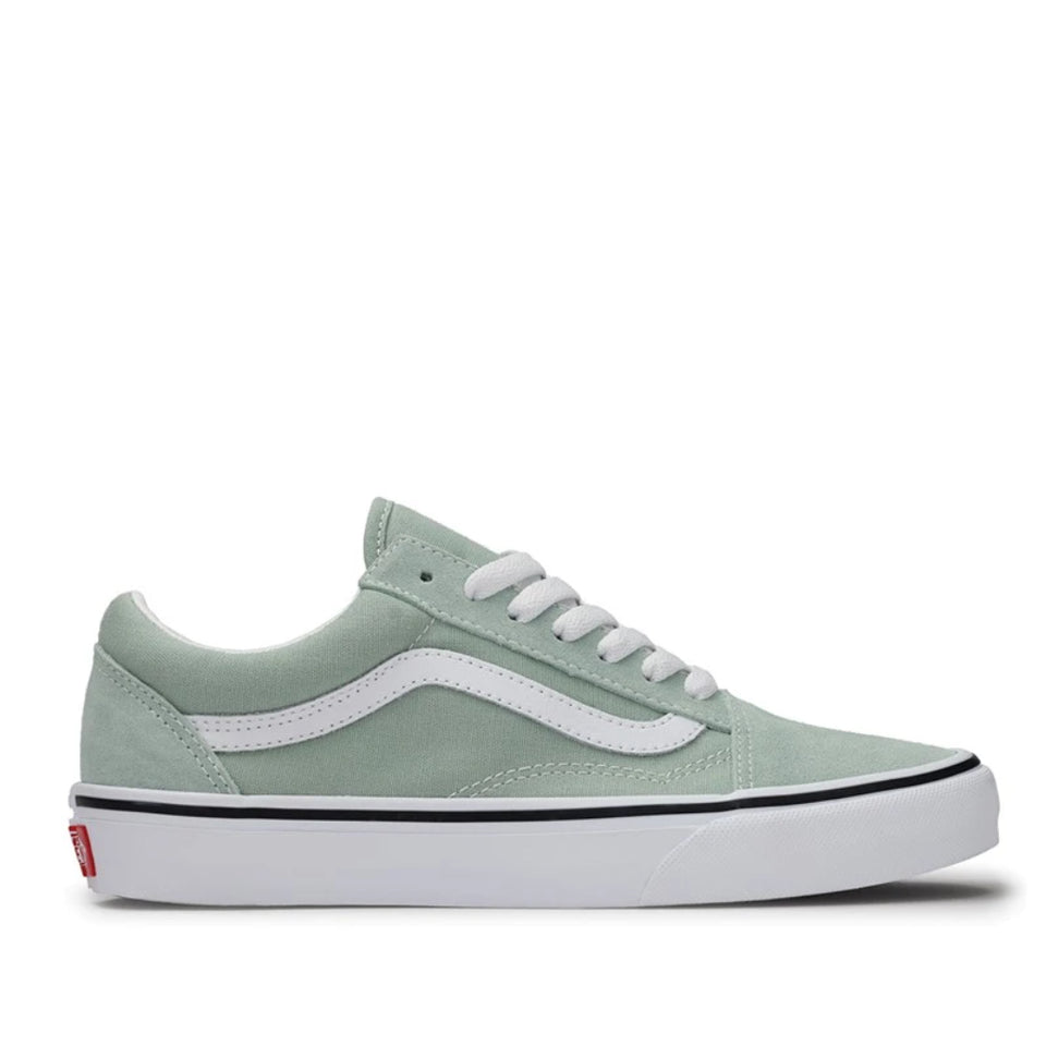 A single Vans Old Skool sneaker in a light sage green colorway, featuring a white side stripe, white laces, and a white rubber sole with a thin black stripe.