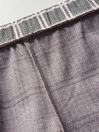 Close-up of gray fabric with a patterned trim at the top