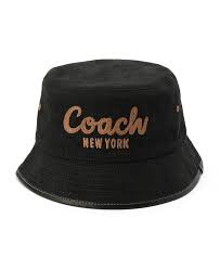 Black bucket hat with 'Coach New York' embroidery on a white background