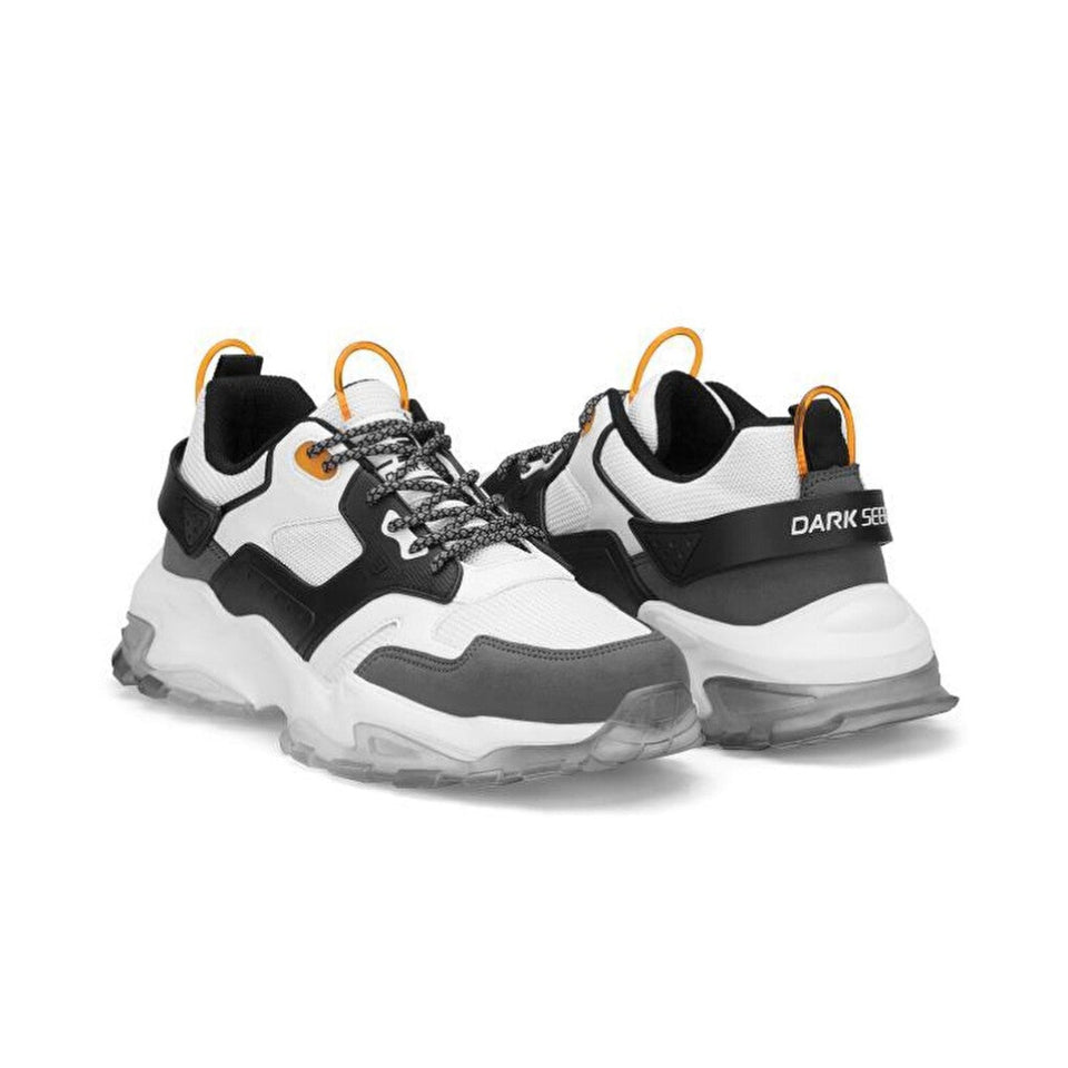 A pair of chunky low-top sneakers in white, black, and gray, featuring bright orange pull tabs and laces, with 'DARK SEER' branding on the side.