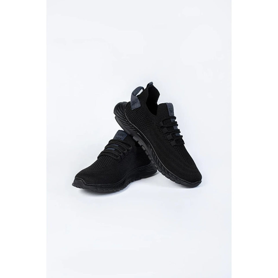 A pair of black athletic sneakers with a breathable mesh upper and thick black soles, displayed on a clean white background.