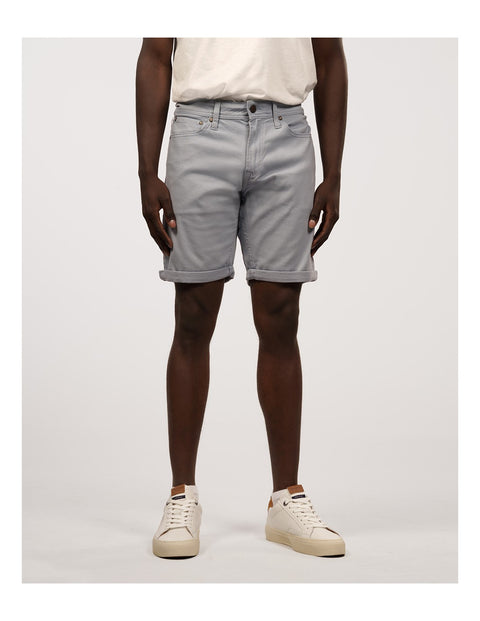 Person wearing light gray shorts on a white background