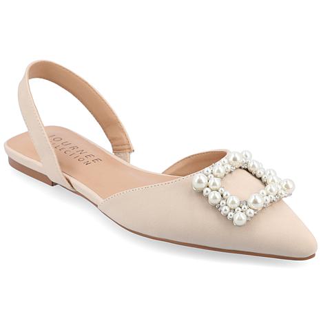 Beige flat shoe with pearl embellishments on a white background