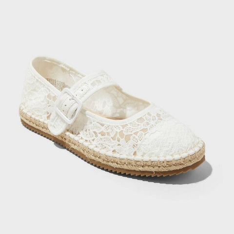 White lace sandal with a brown sole on a light gray background