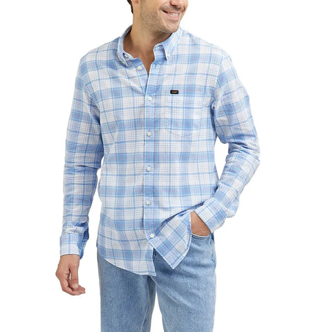 Man wearing a blue plaid shirt and jeans on a white background