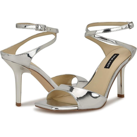 Silver high-heeled sandals with a brand label on a white background