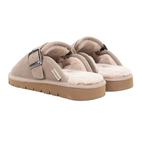 Pair of beige slippers with a buckle on a white background