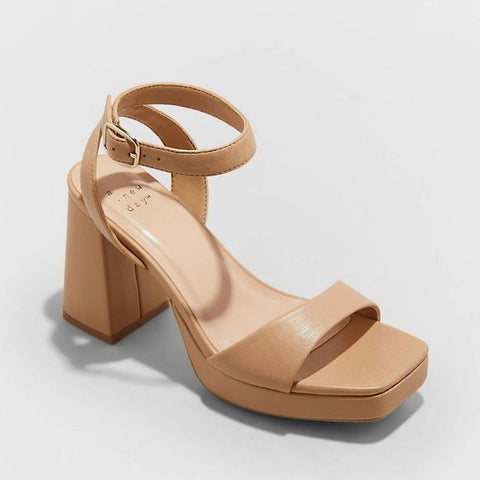 Beige sandal with a block heel on a light gray background