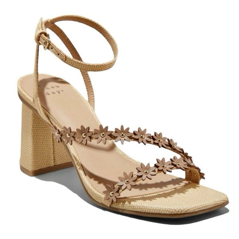 Beige sandal with floral straps on a white background