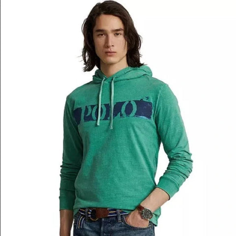 Person wearing a green hoodie with a brand logo on a white background