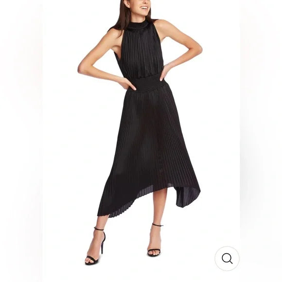 Woman wearing a black pleated dress on a white background