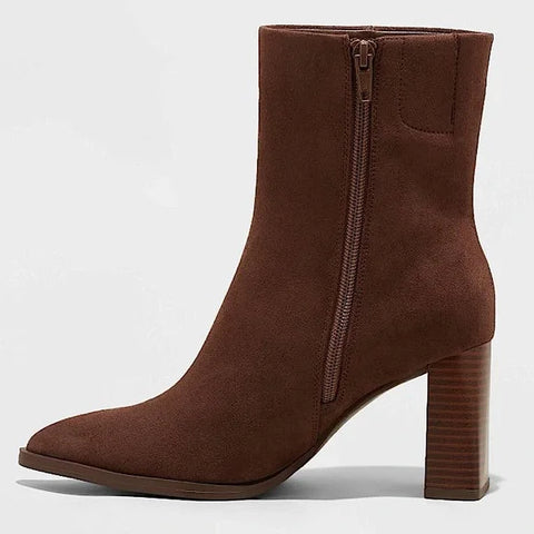 Brown ankle boot with a zipper on a light gray background