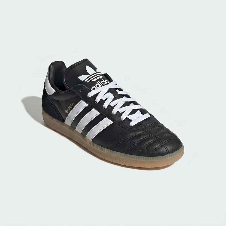 Black Adidas sneaker with white stripes on a light gray background