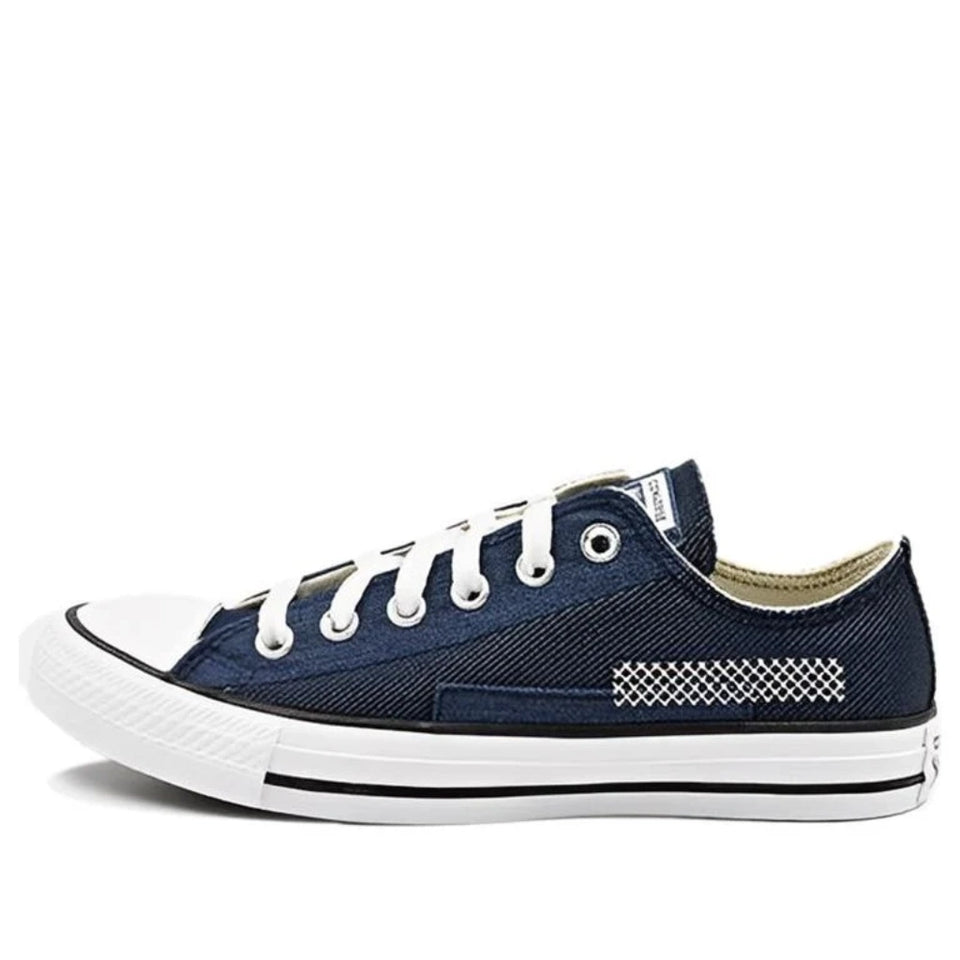 Navy blue sneaker with white laces on a white background