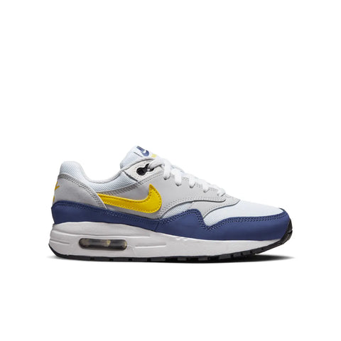 White sneaker with yellow swoosh logo and blue accents on a white background