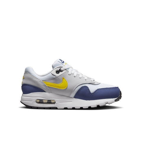 White sneaker with a yellow swoosh logo on a white background