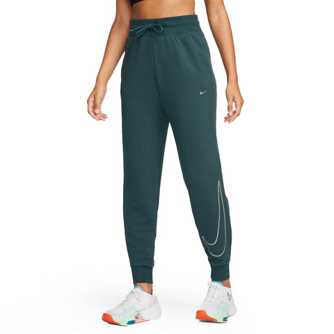 Green Nike jogger pants worn by a person on a white background