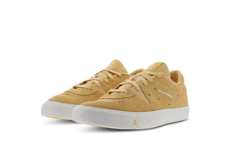 Pair of mustard yellow sneakers with a brand logo on a white background