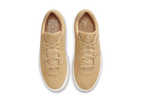 Pair of beige sneakers with brand logo on a white background