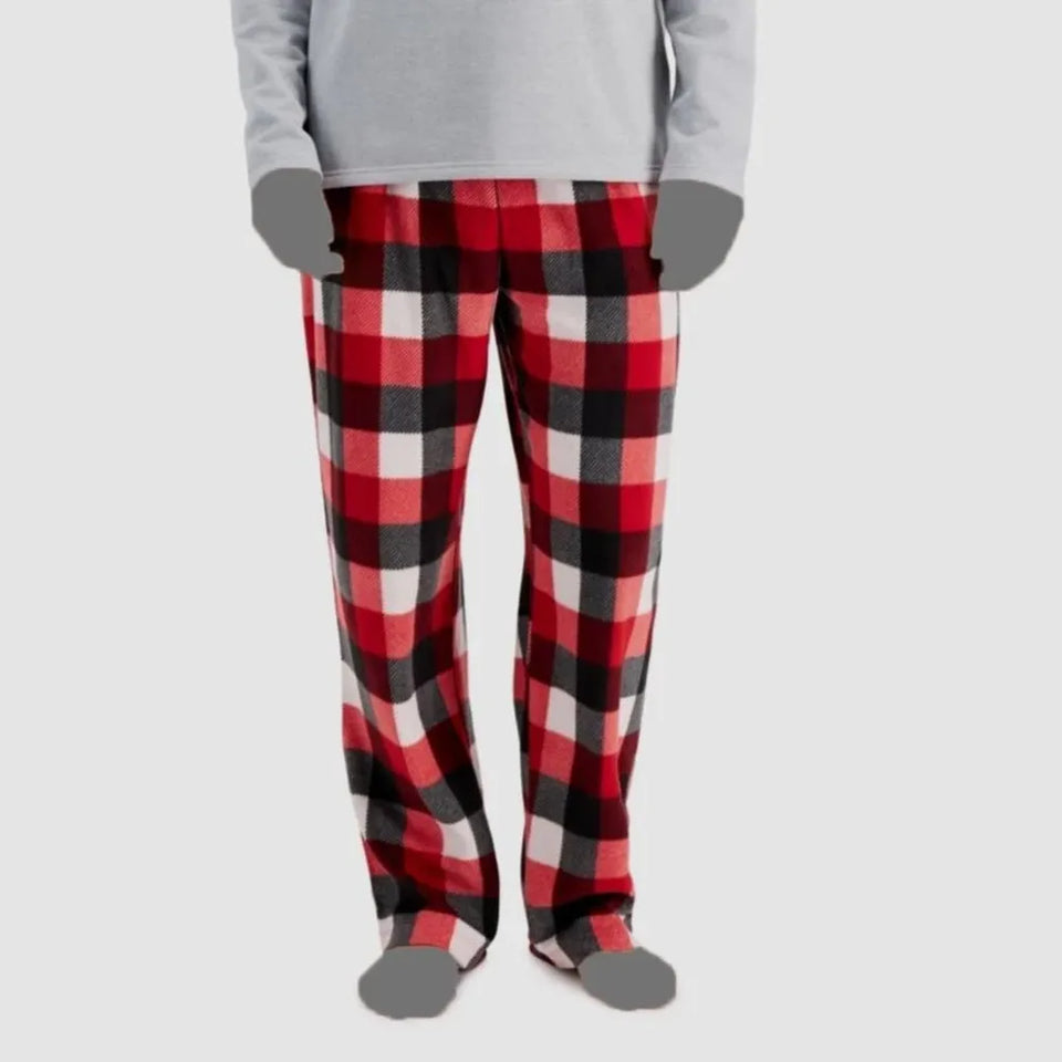 A person wearing red, black, and white buffalo plaid fleece pants with a gray long-sleeve top and gray socks, shown from the chest down on a light gray background.