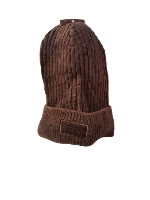 Brown knit beanie with a patch on a desk in an office setting