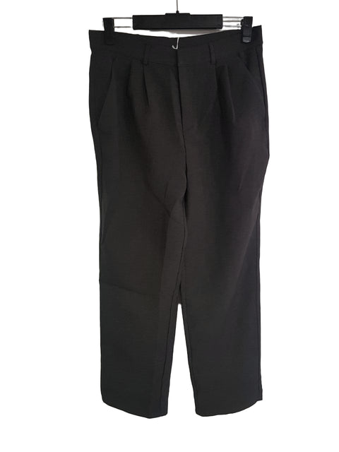 Black pants hanging on a white background