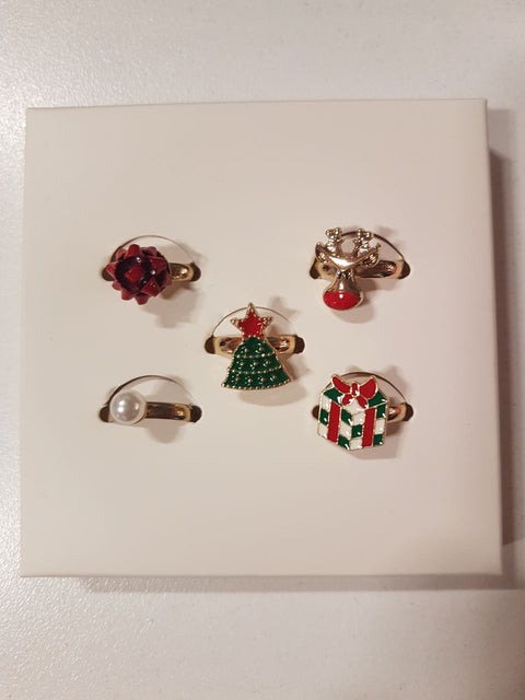 Set of five festive-themed rings on a white card