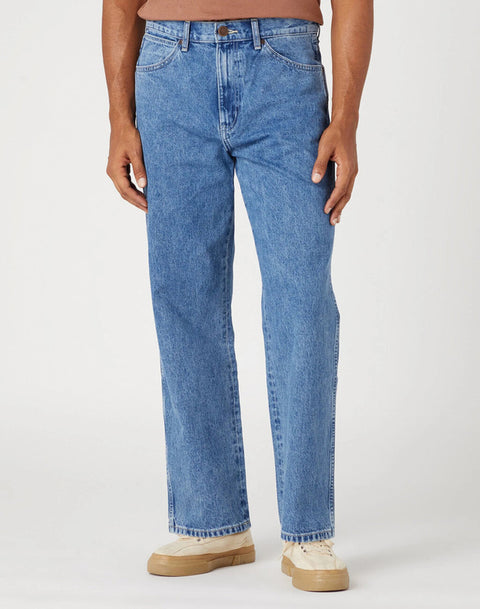 Person wearing blue jeans on a white background