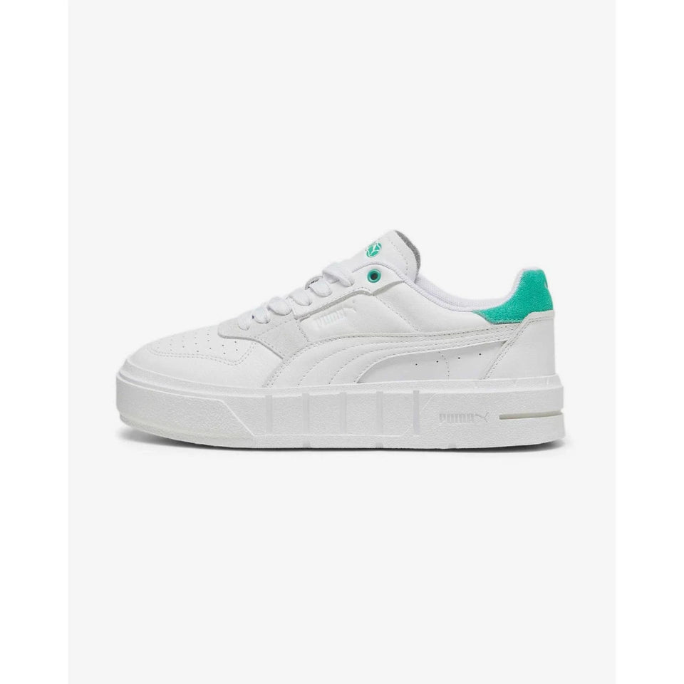 A white Puma platform sneaker with a vibrant mint green heel tab and matching green eyelets, shown in a side profile on a light gray background.
