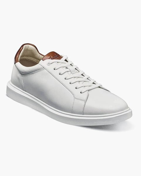 White sneaker with brown accents on a white background