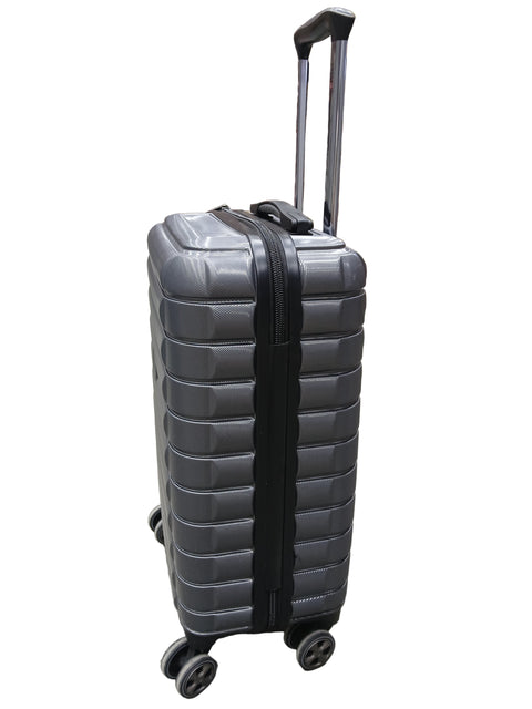 Black suitcase on a gray floor with stacked boxes in the background