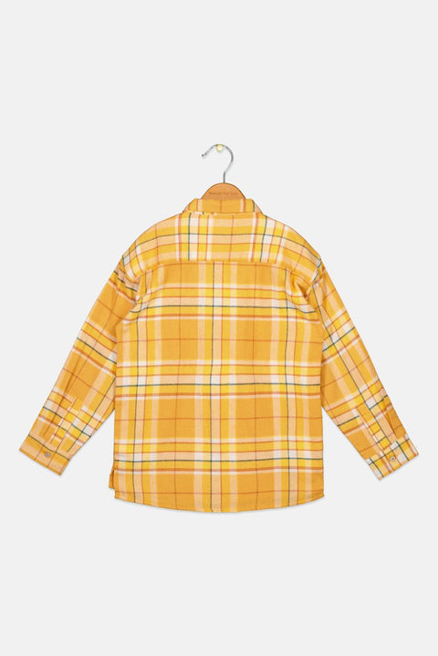 Yellow plaid shirt on a hanger against a white background