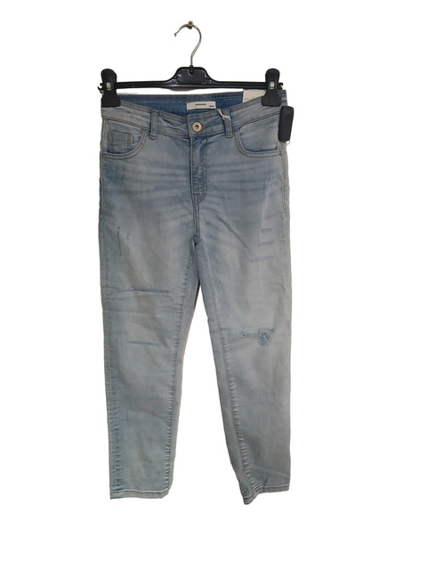 Light blue jeans on a white surface with a black stand.