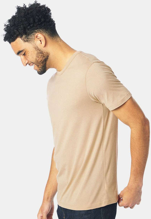 Man wearing a beige t-shirt against a white background