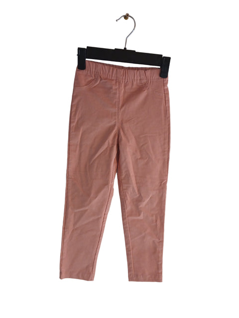 Pink pants on a hanger against a light gray background