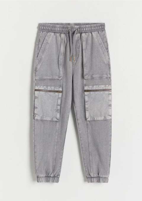 Gray jogger pants with patchwork design on a white background