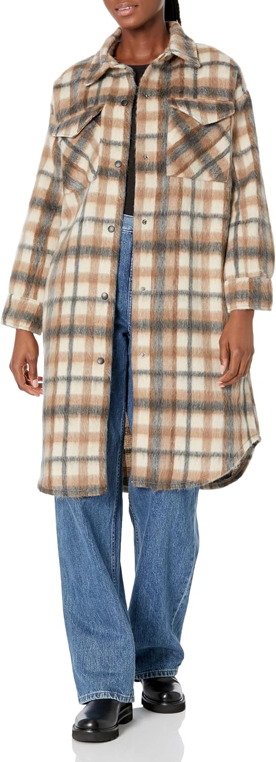 Person wearing a plaid coat over a denim outfit on a white background