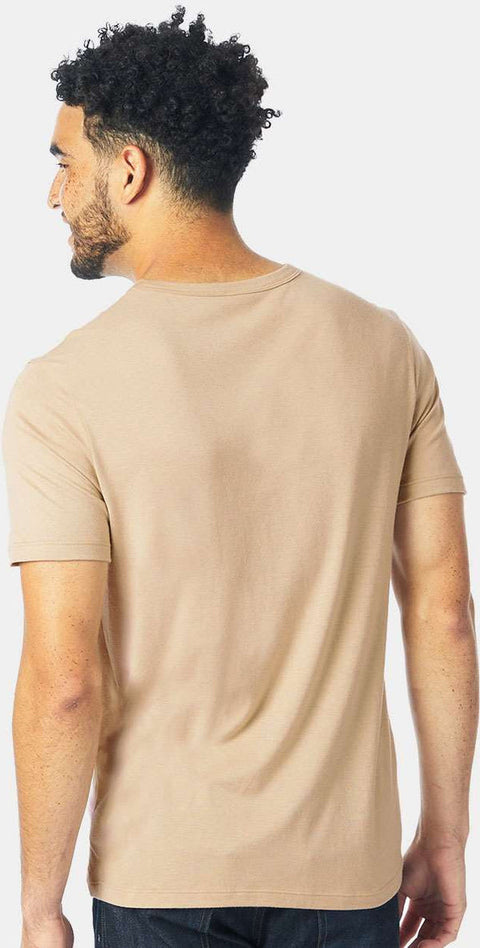 Man wearing a beige t-shirt on a white background