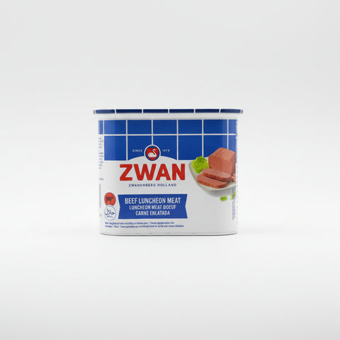 Hand holding a container of Zwan beef luncheon meat with blurred background